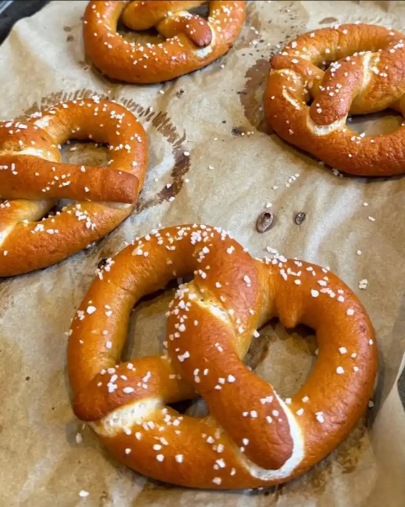 Close-up of a golden-brown gluten-free Bavarian soft pretzel topped with coarse salt.