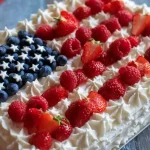 Gluten free American flag cake with fresh berries and frosting