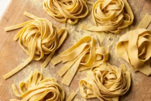 Homemade gluten-free pasta shaped into rustic fettuccine nests