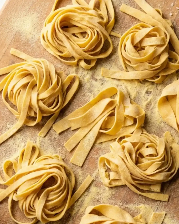 Homemade gluten-free pasta shaped into rustic fettuccine nests