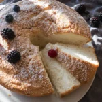 Gluten-Free Angel Food Cake on a white cake stand