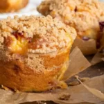 Gluten-Free Peach Streusel Muffins topped with cinnamon crumb and fresh peach pieces.