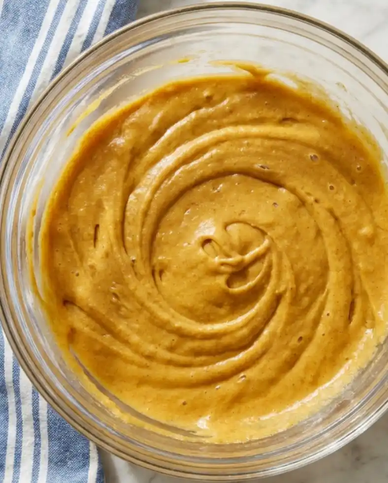 Gluten-free pumpkin cake batter smoothed into a bowl