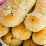 Homemade Gluten-Free Garlic Breadsticks brushed with melted garlic butter and fresh parsley.